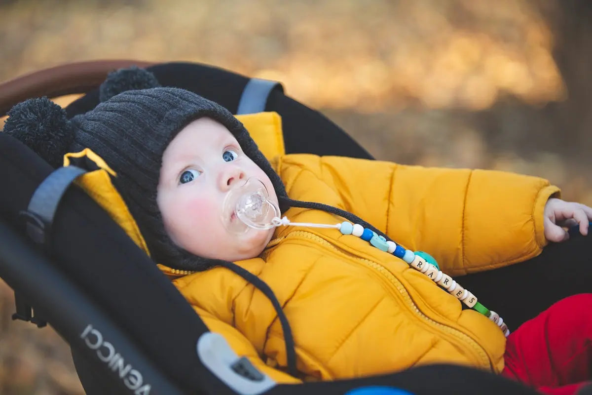 Baby bundled up in a stroller, looking up.