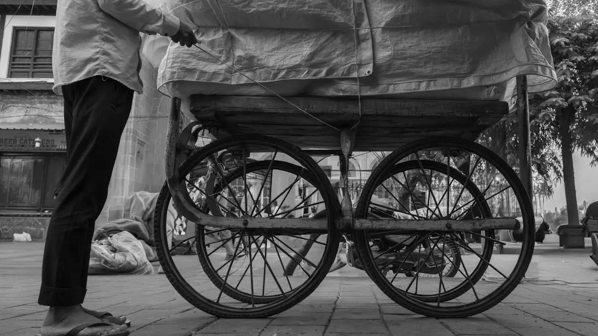 Person pushing a cart with large wheels