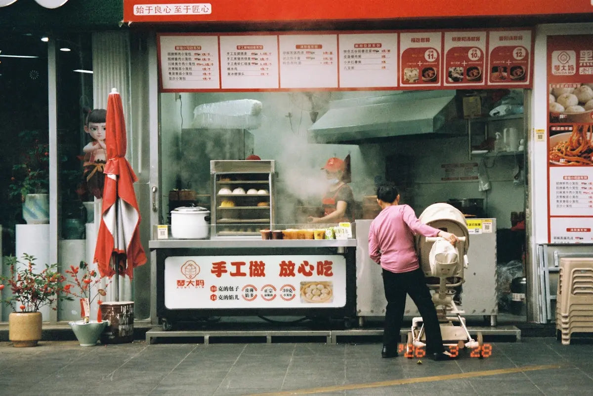 A person preparing food at a street food stall.